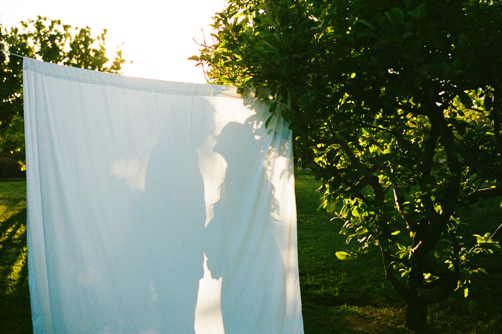 Maternity session in orchard with white sheet backdrop hybrid photography