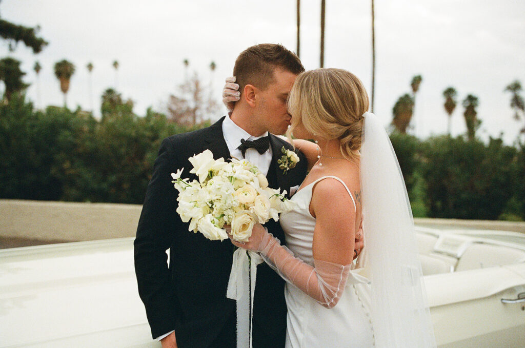 35mm hybrid photography film photo of a couple kissing on their wedding day